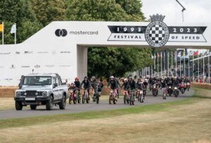 Grenadier Quartermaster in parata con 75 moto fuoristrada per celebrare il 75° anniversario della giacca Belstaff Trialmaster e degli sport motoristici a Goodwood